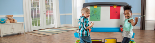 Kindergarten kids playing with easel