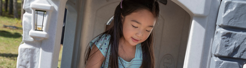 Preschool girl in playhouse