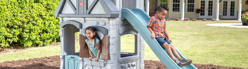 Kids Playing on a Step2 Enchanting Adventures 2-Story Playhouse & Slide with kids play house & kids slide
