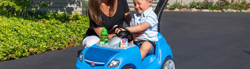 Boy riding in push car