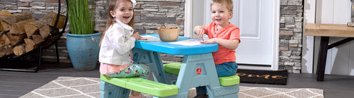 kids sitting at picnic table