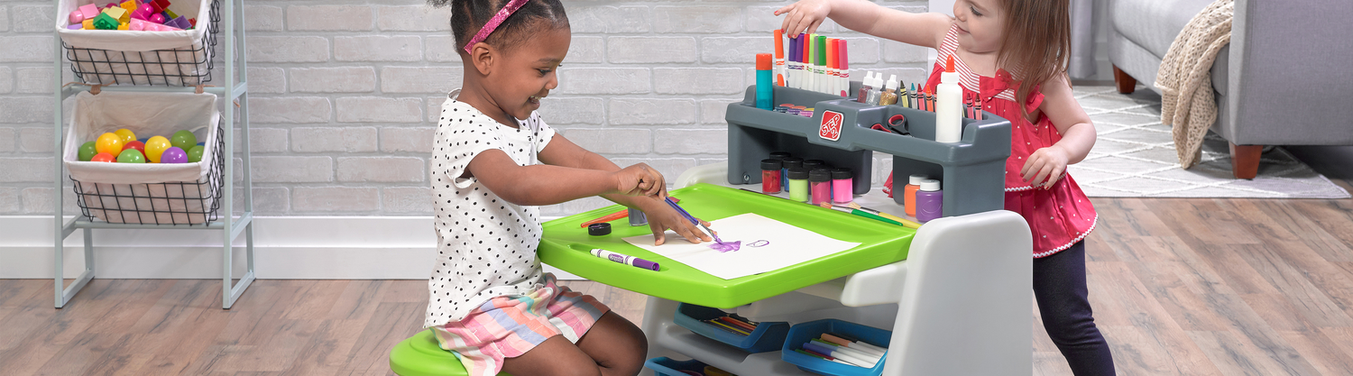 Girls playing at Flip & Doodle desk