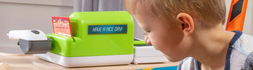 Boy playing with toy register