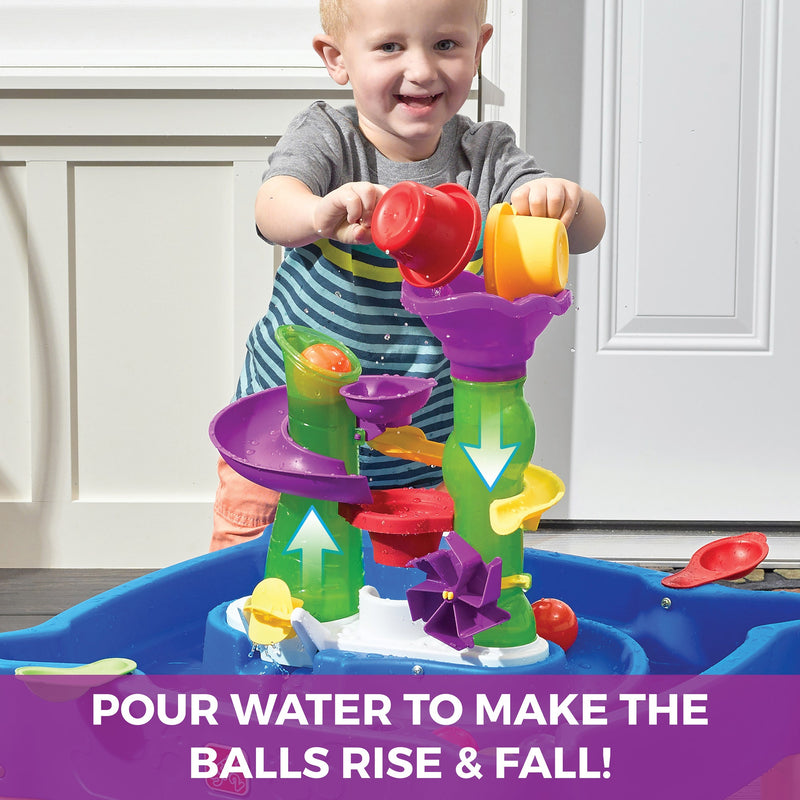 Rise & Fall Water & Ball Table™ boy pouring eater<br />