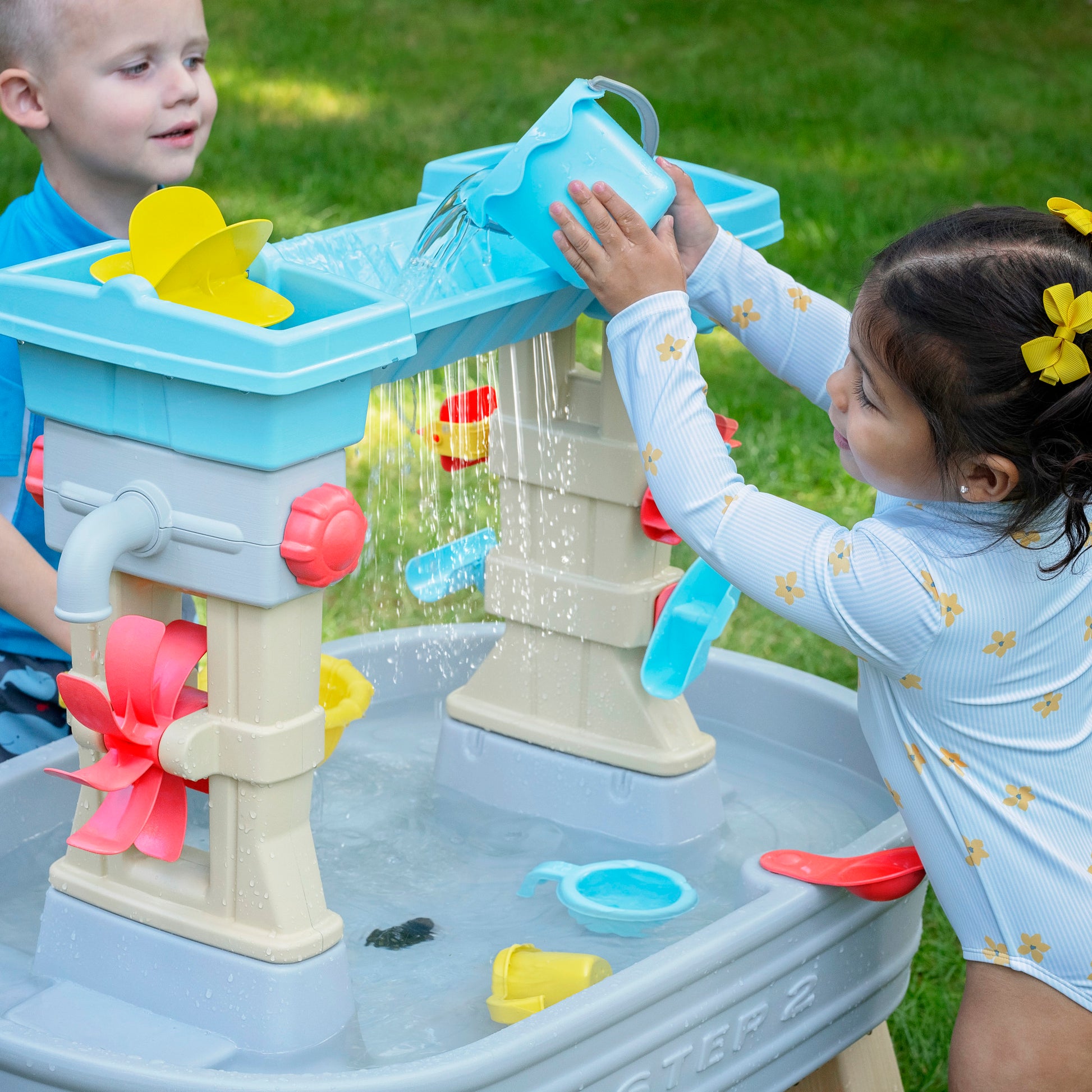 Rain Showers & Flow Water Table with child pouring water