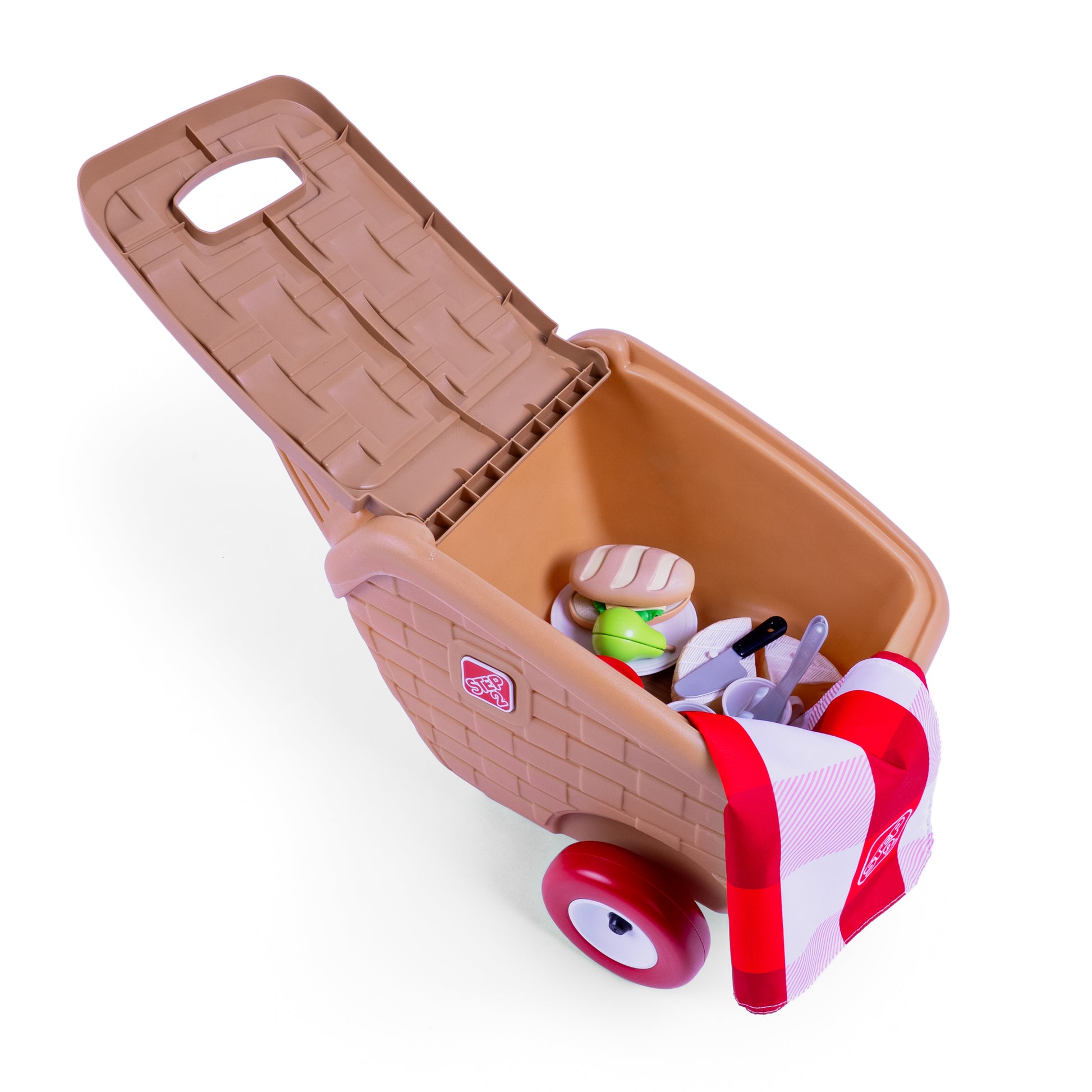 Overhead view of open My First Picnic Basket with toy food accessories and red-and-white checkered blanket packed inside; white background