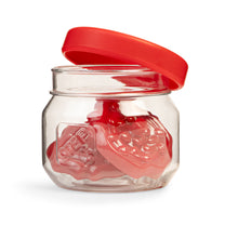 Close-up of toy glass jar with red lid; red jam topping pieces inside with Step2 embossed logo; white background