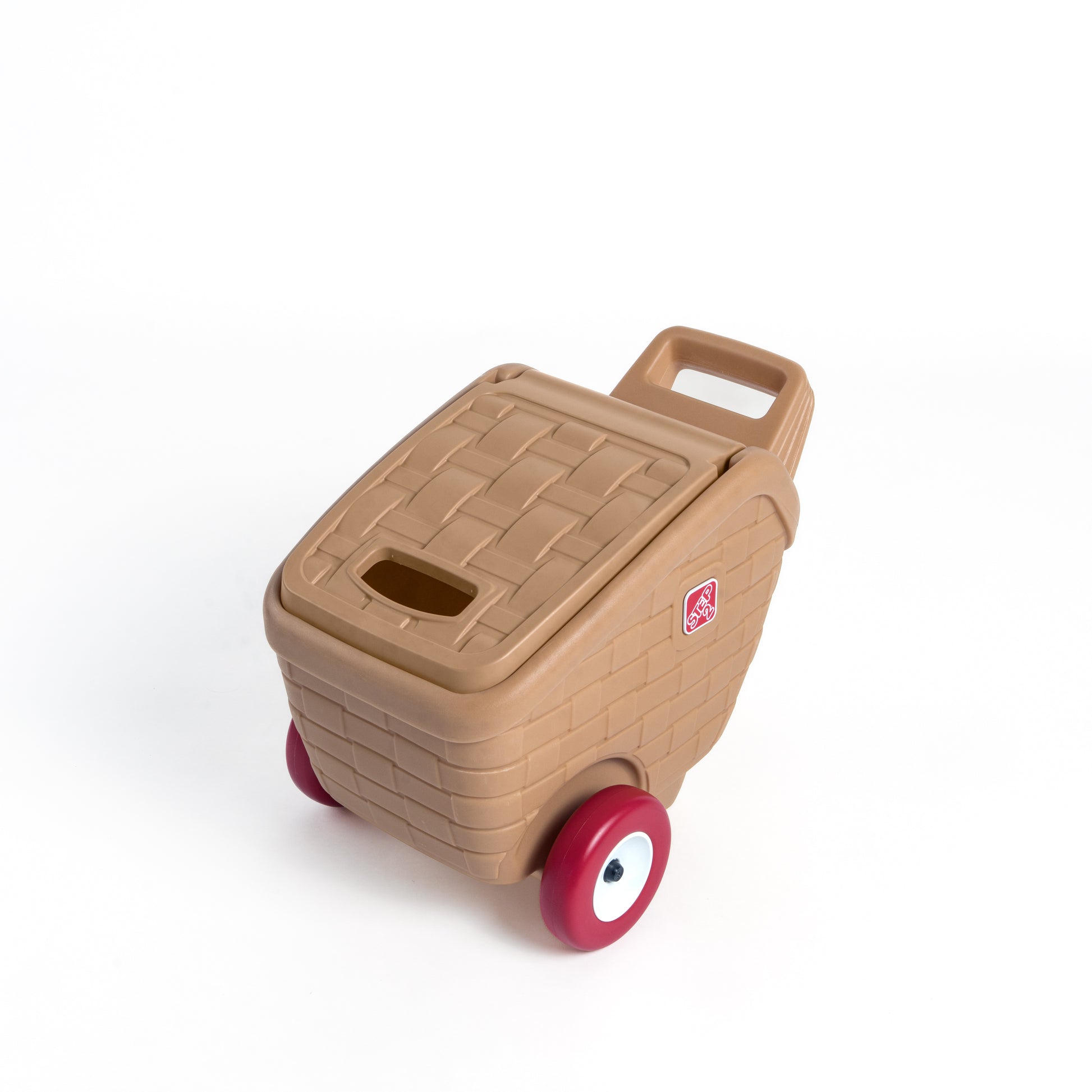 My First Picnic Basket closed — tan wicker-texture body with slot-top lid, top handle, red wheels, and Step2 badge; white background