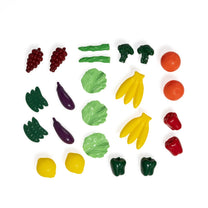 Garden Fresh Kitchen™ play produce flat lay on white background — two grape bunches, asparagus stalks, broccoli florets, orange, cucumbers, eggplants, lettuce leaves, banana bunches, oranges, red peppers, yellow lemon, lemons, and green bell peppers