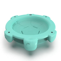 Underside view of Topsy Turtle teal rocking disk showing concave sitting bowl, rubber feet bumps around edge, and product molding, on white background