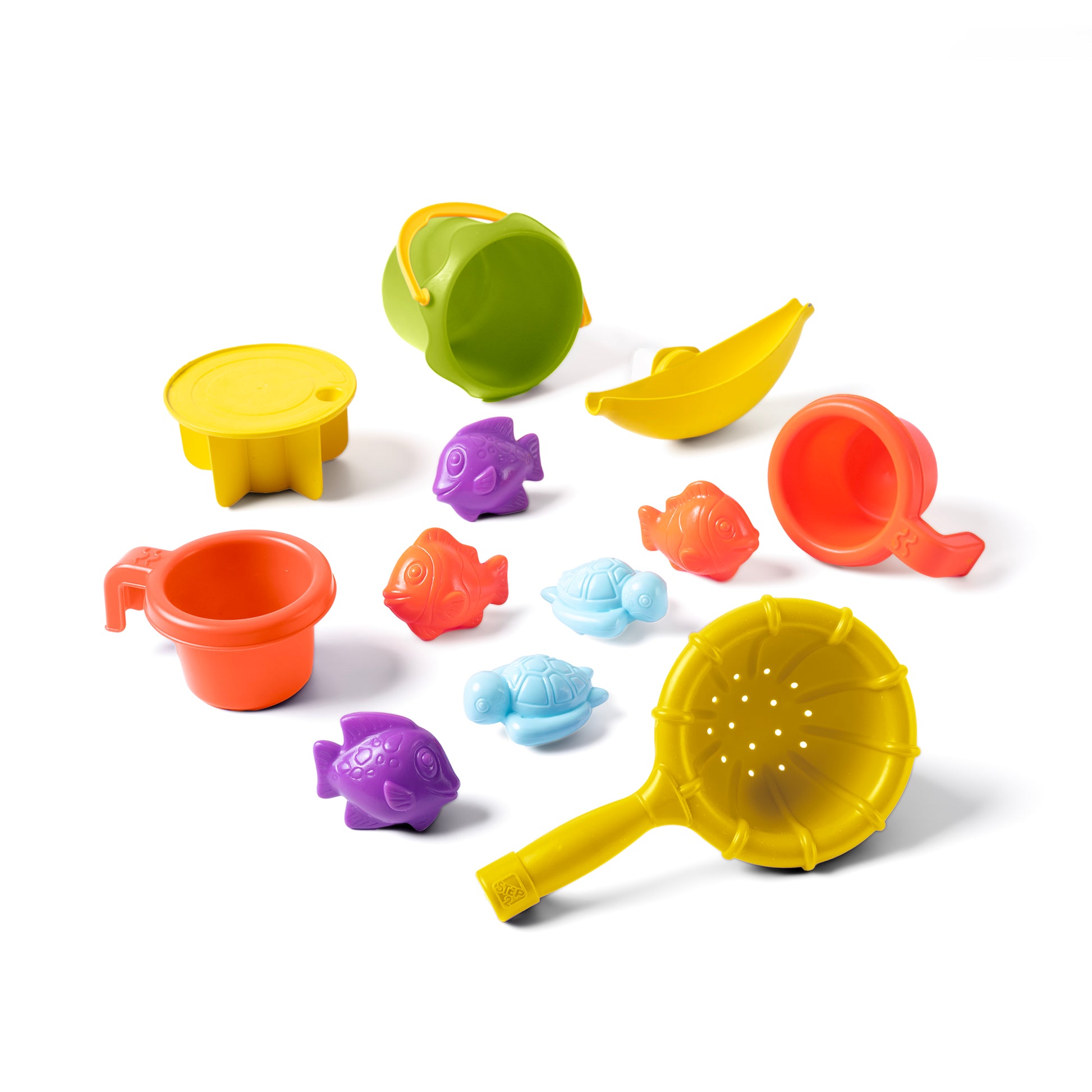 Tropical Splash Water Park™ accessories flat lay on white background — green bucket, yellow sieve, orange cup, banana connector tube, red scoop, purple fish, orange fish, blue turtle, purple turtle, and yellow saucer
