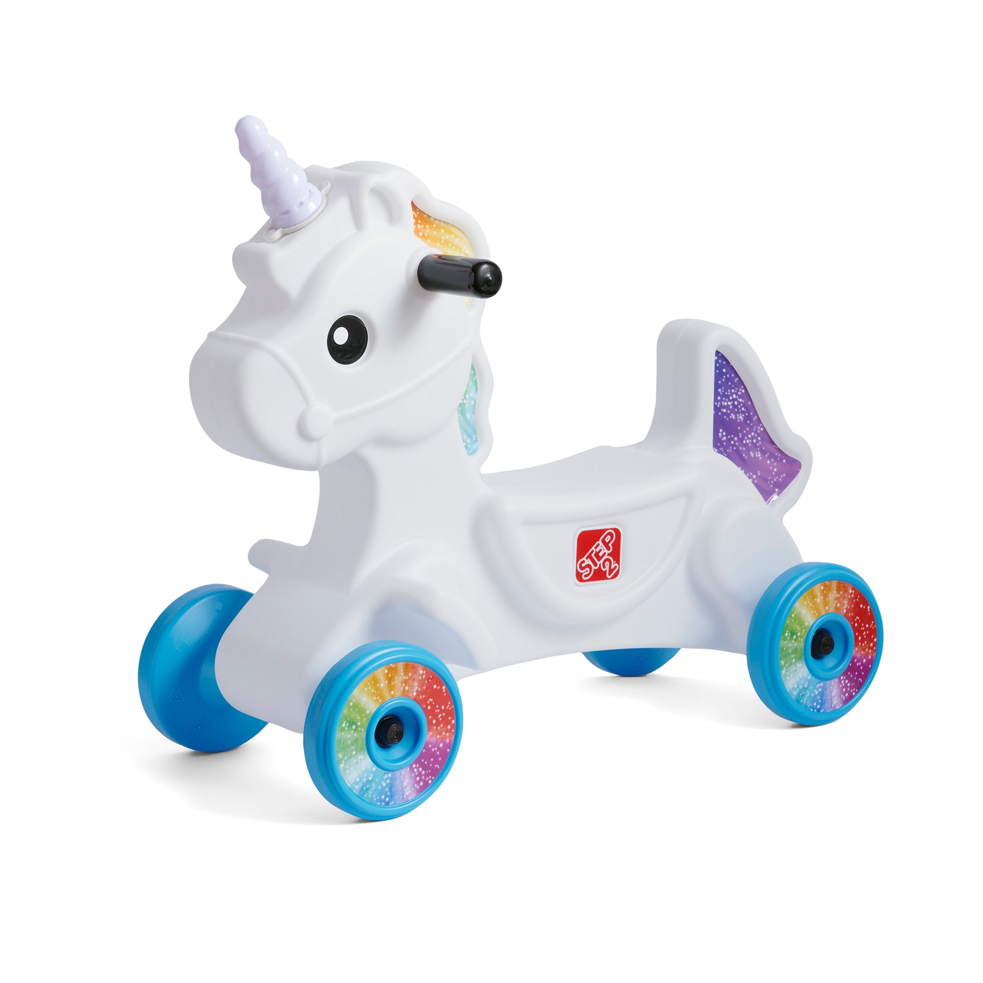 Step2 Unicorn Foot-to-Floor Ride-On Car™ — white unicorn body with purple sparkle horn, gold-painted mane, and rainbow swirl wheels with blue rims; 3/4 front-left view on white background