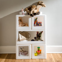 Contemporary Builders Stackable Storage Cubes in white with stuffed animals and accessories — ballet slippers, books, purse, colored pencils, teddy bear in girls room