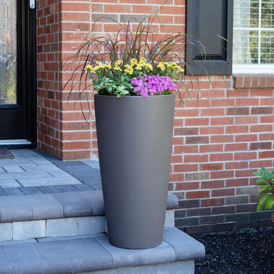 Tremont Tall Round Tapered Planter™ - Dark Cedar with flowers