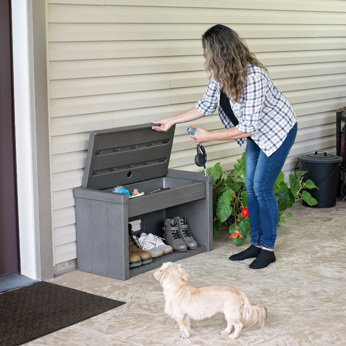 Lakewood Boot Bench woman removing item for under bench storage.