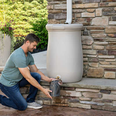 Fernway Rain Barrel™ man retrieving water from spigot