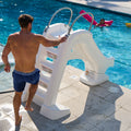 Vero Pool Slide™ with adult ready to go up the steps.