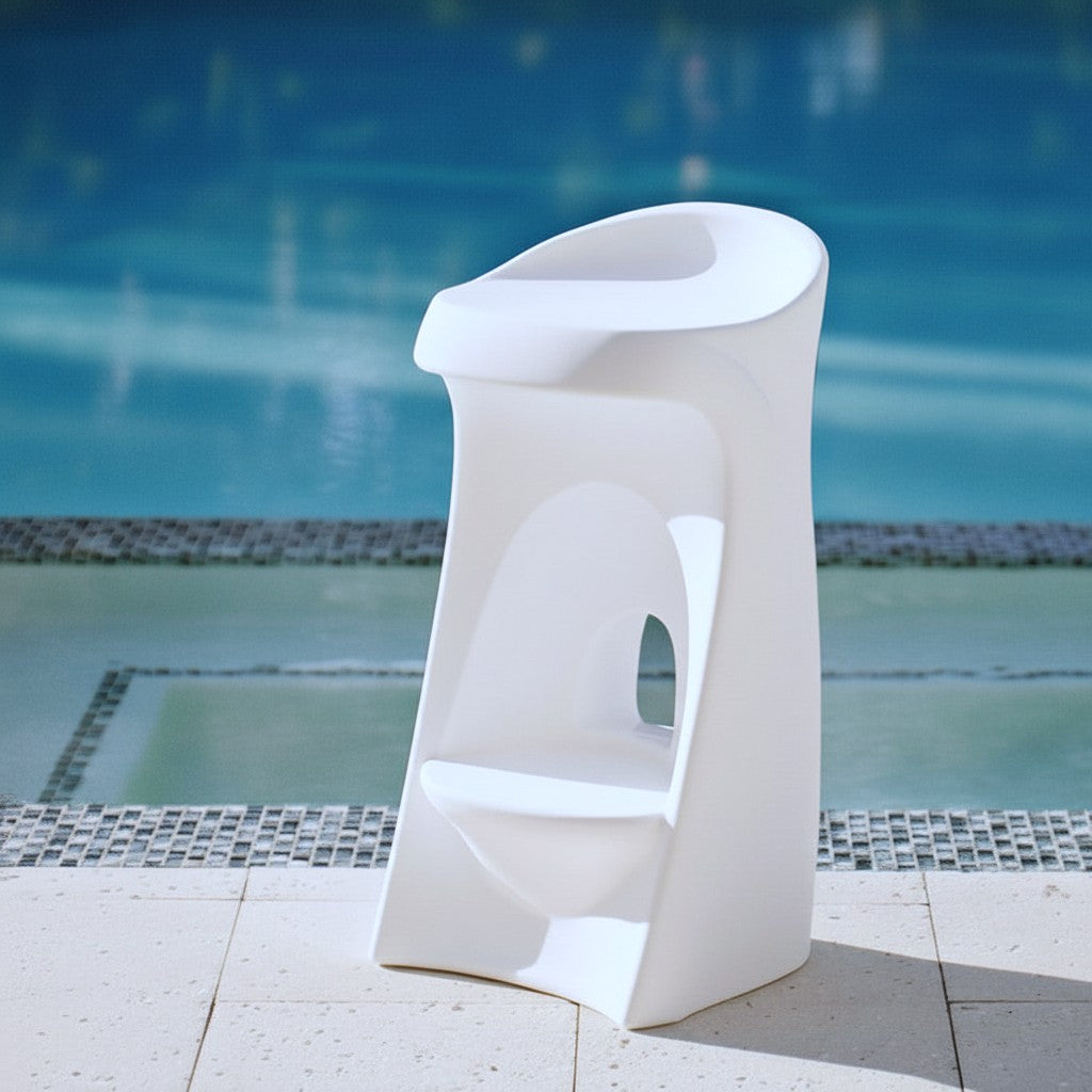 Step2 Vero In-Pool Stool in white — tall sculptural bar-height pool stool with curved contoured seat and oval cutout in the base column; standing on stone pool deck with pool behind