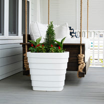 Wave Planter™ 20X24 White 2 Pack one shown with plants on porch