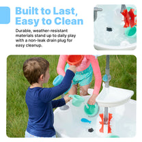 Built to Last, Easy to Clean — Sunshine Springs Splash Table; top-right inset shows close-up of white basin with black drain plug and accessories; boy in blue shirt and girl in pink pouring water from teal cups at table on grass; "Durable, weather-resistant materials stand up to daily play"