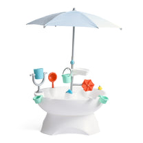 Step2 Sunshine Springs Splash Table with CoolBreeze Misting Canopy — white oval basin on pedestal with light blue umbrella, orange water wheel, teal bucket, and accessories, on white background