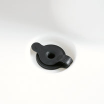 Close-up of black drain plug in white Sunshine Springs Splash Table basin