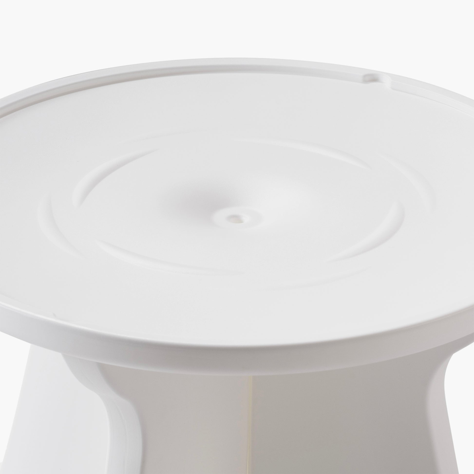 Close-up overhead view of the Vero In Pool Accent Table™ surface — shows round tabletop with concentric raised ring and central drain hole in the white matte finish