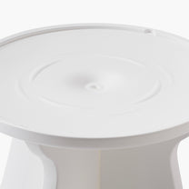 Close-up overhead view of the Vero In Pool Accent Table™ surface — shows round tabletop with concentric raised ring and central drain hole in the white matte finish