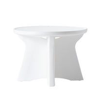 Front view of Vero In Pool Accent Table™ on white background — shows round tabletop with raised lip edge, curved hourglass-shaped center column, and four-panel star base