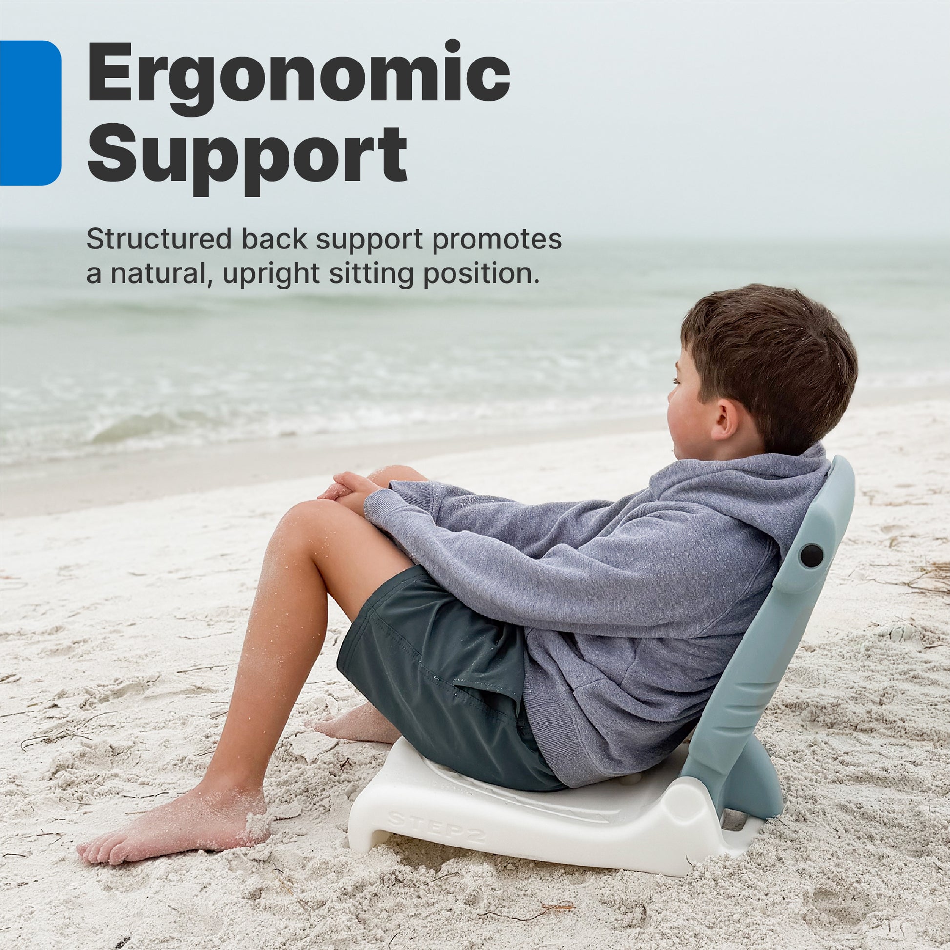 Kids Hammerhead Flip Seat — older boy in gray hoodie sitting on hammerhead seat on beach looking at ocean