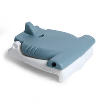 Kids Hammerhead Flip Seat in gray folded flat, front-right angle — hammerhead fin on top, carry hole, and eye detail; STEP2 on white base, on white background