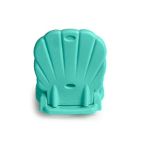 Back view of Kids Seashell Flip Seat in teal folded flat — ribbed shell pattern with carry handle hole, STEP2 embossed, on white background