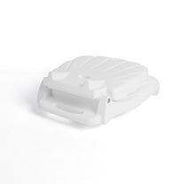 Seashell Flip Seat in white folded flat — overhead angled view showing compact form with shell ribbing and carry handle gap, on white background