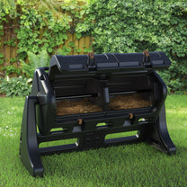 EverTough Tumbling Composter on lawn with both hatches and doors open showing dark compost inside
