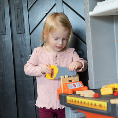 Deluxe Workshop girl using saw.