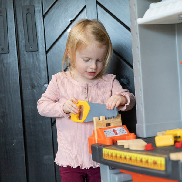 Deluxe Workshop girl using saw.