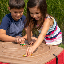 Naturally Playful™ Sand Table™ lid is an additional play surface with molded roadways