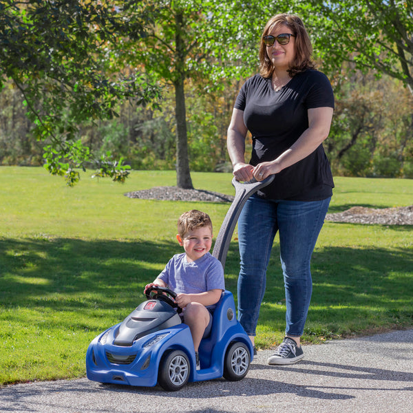 Push Around Buggy GT™ - Blue with child being pushed in buggy