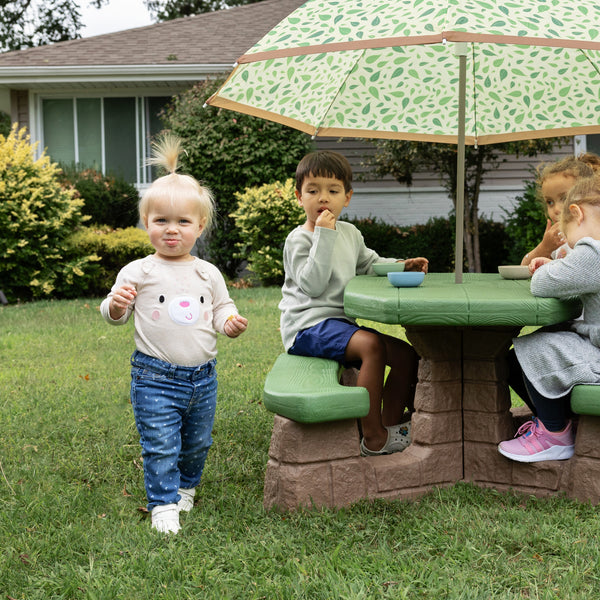 Naturally Playful™ Picnic Table with Umbrella™ - Leaf with kids eating