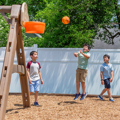 Naturally Playful™ Adventure Lodge Play Center boys playing basketball
