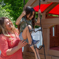 Naturally Playful™ Adventure Lodge Play Center with Glider girl climbing rope ladder