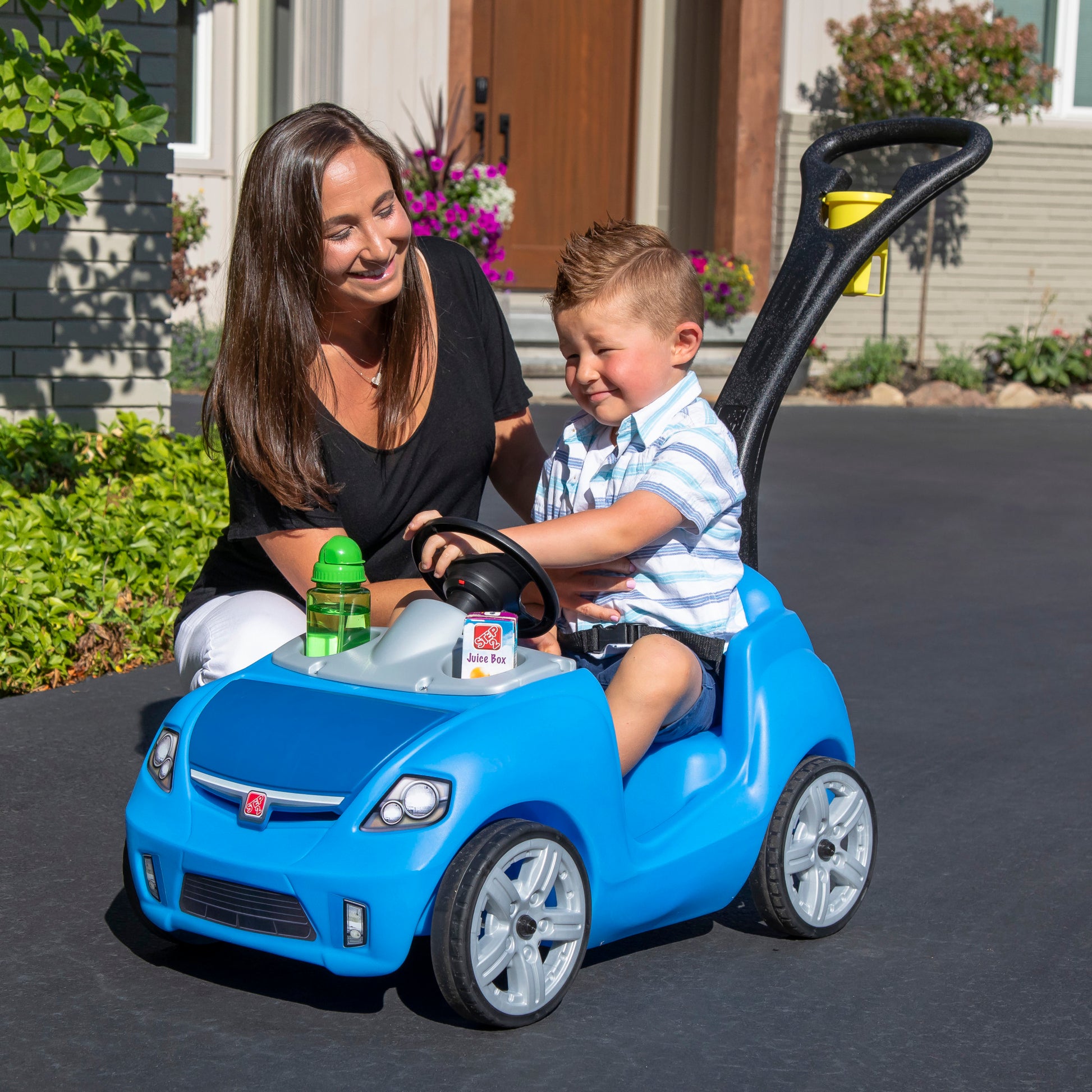 Whisper Ride II™ - Blue with child sitting in car