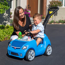 Whisper Ride II™ - Blue with child sitting in car