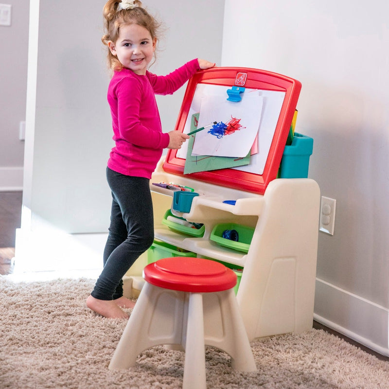 Flip and Doodle Easel Desk with Stool girl painting on easel.