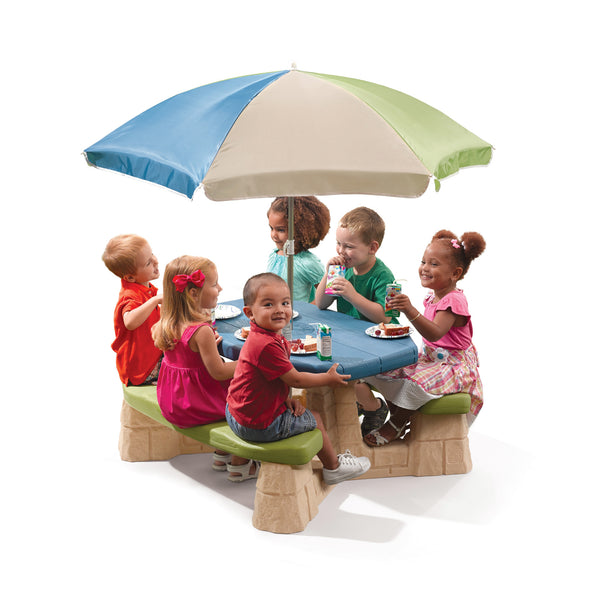 Naturally Playful™ Picnic Table with Umbrella™ - Earth with kids seated