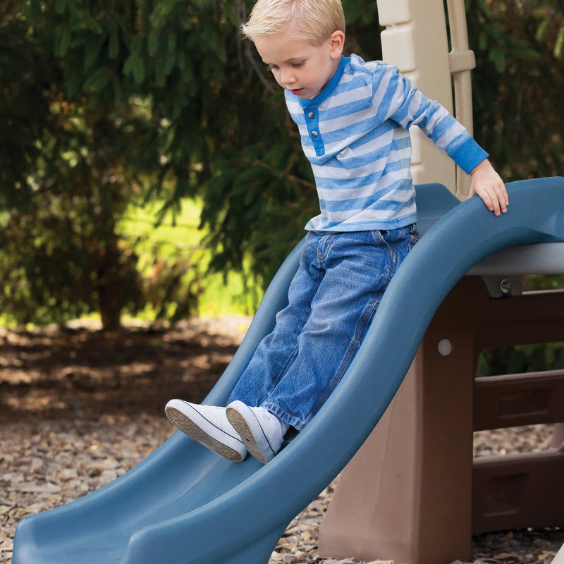 Play Up Gym Set™ boy sliding down slide<br />