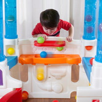 WonderBall Fun House™ child dropping ball through holes
