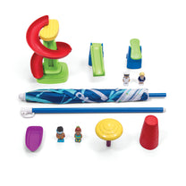 Fiesta Cruise Water Table accessories flat lay — spiral water tower, green slide, 4 figures, umbrella with pole, purple boat, yellow spinning wheel, and red cup