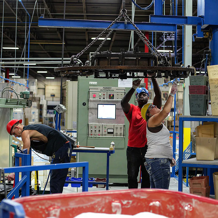 Workers operating machinery in a factory setting